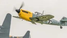 A photo of a Messerschmitt Bf 109 flying in the sky.